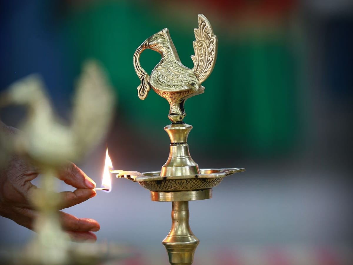 Lighting an ornate traditional brass oil lamp