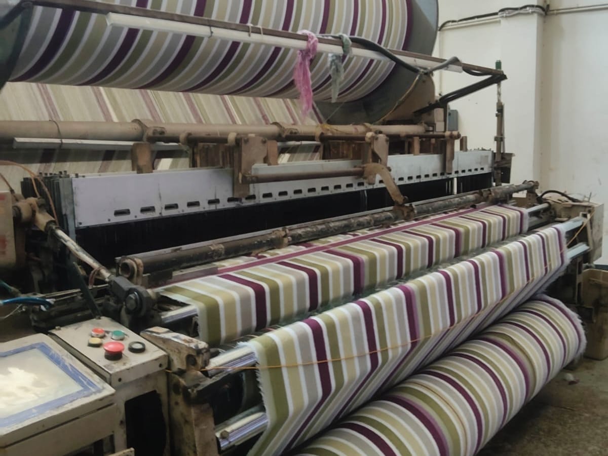 Loom weaving striped fabric, textile unit