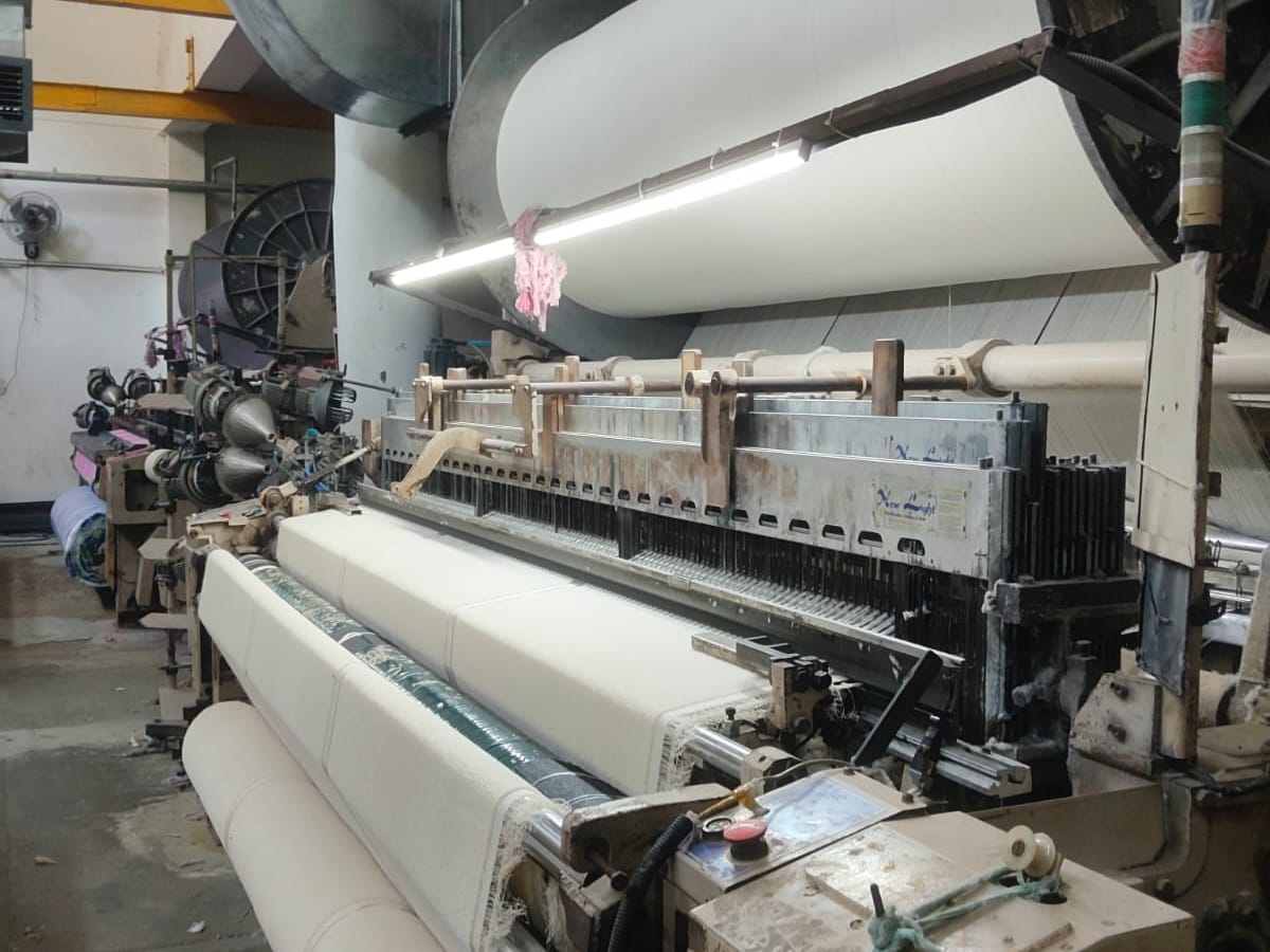 Industrial weaving machinery on factory floor