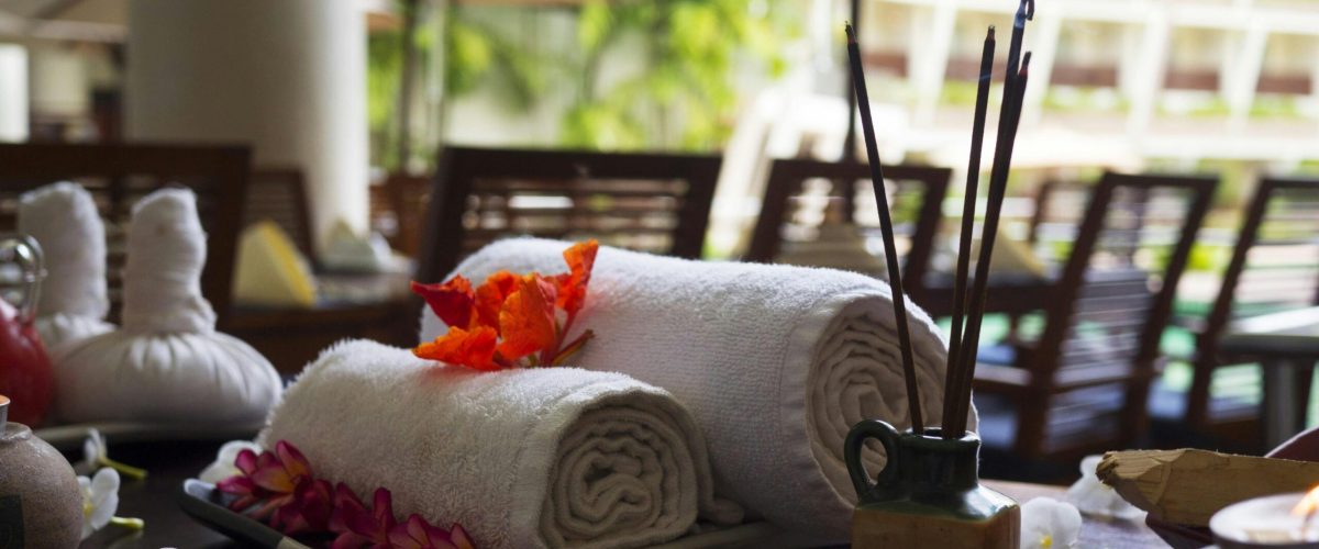 Home Relaxing spa scene with towels, incense, and flowers, perfect for wellness themes.