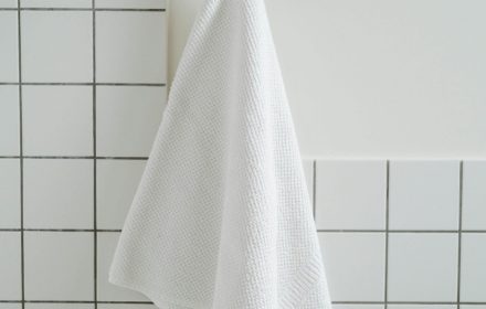 pexels photo 8142193 8142193 Simple white towel hanging in a contemporary bathroom with tiled wall.